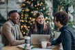 © Fox - During a cheerful business gathering at a cafe adorned with holiday decorations, colleagues engage in collaborative work over laptops and coffee, creating a productive and festive environment