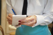 © Towfiqu Barbhuiya  - a waiter writing oder on a notebook