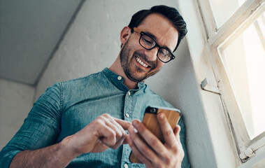 Leinwandbilder - Cellphone, businessman and low angle in office for research, thinking and website design. Smartphone, scroll and creative engineer in workplace for digital project, development or startup application