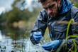 © Emanuel - Man environment researcher inspecting water sample from lake. Ecology field research