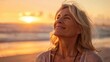 © Thanos - Mature Woman Breathing Ocean Air on Beach at Sunset, Smiling and Happy