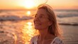© Thanos - Mature Woman Breathing Ocean Air on Beach at Sunset, Smiling and Happy