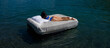 © Volodymyr - Comfort cozy bed concept. Woman with inflatable mattress in summer water. Sexy woman sleeping or resting on a mattress in the water. Water mattress concept. Sweet dreams. Summer rest.