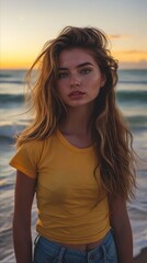 Poster - A young woman in yellow shirt standing on the beach.