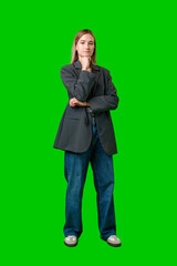 Wall Mural - Young Woman Standing With Her Arms Crossed In Front Of A Green Screen