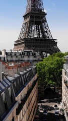 Wall Mural - Eiffel Tower in Paris, France, aerial view. Vertical video view from a drone. The main tourist attraction of Paris