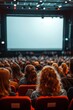 © pornsawan - People in the cinema auditorium with Cinema blank wide screen and red chairs in the cinema hall,People silhouettes watching movie performance,empty white screen,space for text.