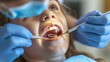 © Tahir AI - Side view of a young patient during a dental check, dentist scaling her teeth in a well-equipped clinic room