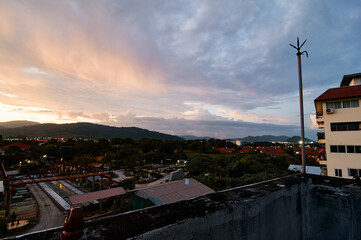 Wall Mural - Dramatic landscape with view on evening city. Beautiful cloudy sky.