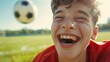 © RDO - A close-up of a young teen's face, joyfully playing soccer, with the field's background soft and a clear sky above for text.