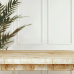 Poster - Empty wooden tabletop for product placement with white wall and tropical plant shadow
