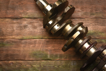 Wall Mural - Old car crankshaft on the wooden workbench flat lay background with copy space.