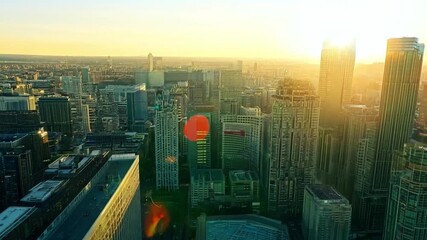 Wall Mural - A city skyline at sunrise, with buildings illuminated by the golden light. Bright, warm lighting to highlight the cityscape.