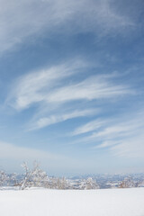 Wall Mural - white clouds in winter sky above frozen snow landscape in hokkaido japan