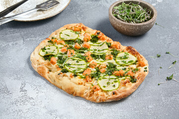 Wall Mural - Delicious Roman Pizza with Zucchini and Salmon Topped with Fresh Greens