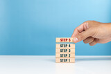 Step, begin, important start, method and step process concept. Hand arrange the wooden blocks of step 1 to 5 indicating task priority and management
