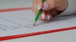 © kinomaster - Close up shot of woman at the desk working with important exam document, student reading and picking answers in test, circling with pencil letters for questions.