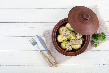 Wall Mural - Stewed potatoes with meat, onions and herbs in a jug