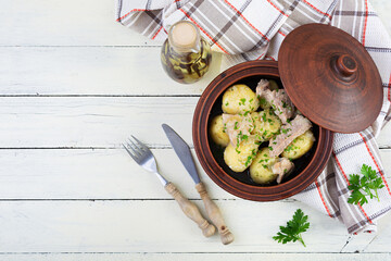 Wall Mural - Stewed potatoes with meat, onions and herbs in a jug