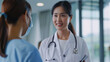 © Chatchanan - An Asian female doctor explaining medical test results on a digital screen to a patient, with a reassuring smile.