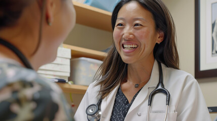 An Asian female doctor smiling, displaying a digital screen to a patient, and explaining their test results during a consultation.