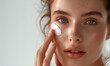 © Q STOCK - Hydration. Cream smear. Beuaty close up portrait of young woman with a healthy glowing skin is applying a skincare product