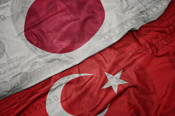 Sticker - waving colorful flag of japan and national flag of turkey on the dollar money background. finance concept.