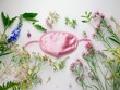 © vefimov - Pink sleep mask on white surface with pink flowers