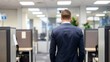 © nuttapong - Rear view of a businessman walking through a modern office corridor, emphasizing professional work environment and corporate culture.