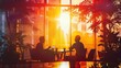 © nuttapong - Silhouette of two people having a meeting in a modern office with a sunset view through large windows and indoor plants.