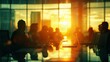 © nuttapong - Silhouettes of business professionals in a meeting room with a beautiful sunset view, capturing teamwork and collaboration in a corporate setting.