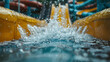 © khonkangrua - Close-up view of water splashing on a vibrant yellow water slide, capturing the fun and excitement of a water park.