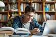 © Igor - Determined college boy sitting at a study desk, surrounded by books and papers