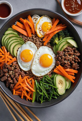 Wall Mural -  Steaming bowl of Korean bibimbap with colorful vegetables, a fried egg, and gochujang sauce. 