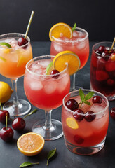 Wall Mural -  Close-up of colorful cocktails with garnishes like citrus slices and cherries. 