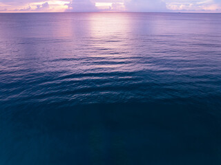 Landscape Aerial view of majestic clouds in the sky sunset or sunrise over sea with reflection in the tropical sea