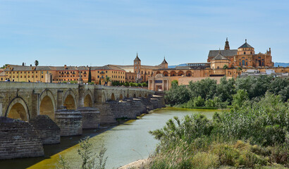 Wall Mural - Panoramic view of the Mosque-Cathedral across the Calahorra Tower and the Roman Bridge over the Guadalquivir River, Cordoba, Andalusia, Spain.