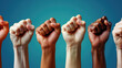 © RISHAD - Diverse group of raised fists in various skin tones, symbolizing unity, strength, and solidarity against a blue background, promoting equality and empowerment.