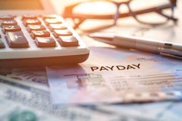 Wall Mural - Calculator and paycheck on a desk representing payday and financial management