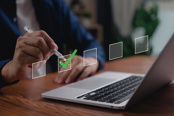 Businessperson completing digital checklist on laptop. Concept of productivity and task management. Useful for project planning, organizational strategy, and corporate efficiency visuals.