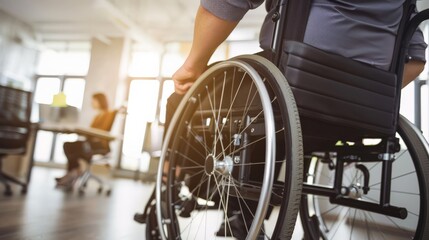 Poster - Close-up of a person in a wheelchair in an office with colleagues in the background. Promotes workplace inclusion and diversity for disabled employees.
