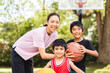 © Louis-Photo - Basketball, family and teaching sport with a mom and son training on a court outside for leisure fitness and fun