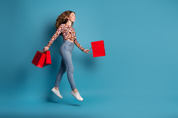 Sticker - Full size photo of nice young girl bags jump empty space wear top isolated on blue color background