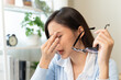 © Pormezz - woman taking off glasses tired of computer work suffering from eye strain tension