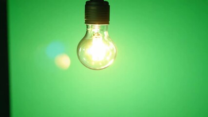 Poster - Old Fashioned Flickering Lightbulb on a Green Screen, symbolizing Idea, Innovation, Thought, Inspiration