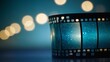 © Deivison - Unrolled film reel and a strip of film, bokeh background, cinema and movie concept.