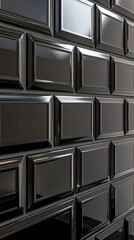 Poster - A close-up view of a wall constructed of numerous black cubes of varying sizes and arrangements, creating a geometric abstract background