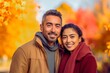 © Pajaros Volando - Latin American couple posing in outdoors with autumn colors behind