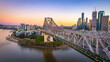 © AmazingAerialAgency - Aerial view of Brisbane city skyline at sunset with Story Bridge and Brisbane River, Brisbane City, Queensland, Australia.