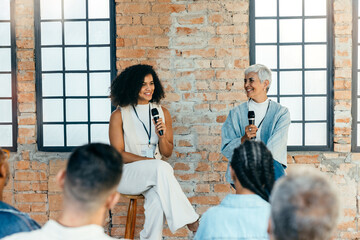 Women discussing business with audience